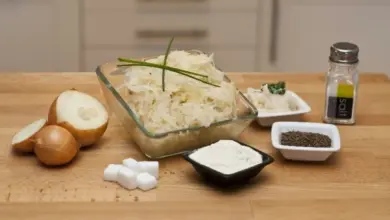 Kysané zelí s ingrediencemi jako cibule, cukr a sůl na dřevěném povrchu.
